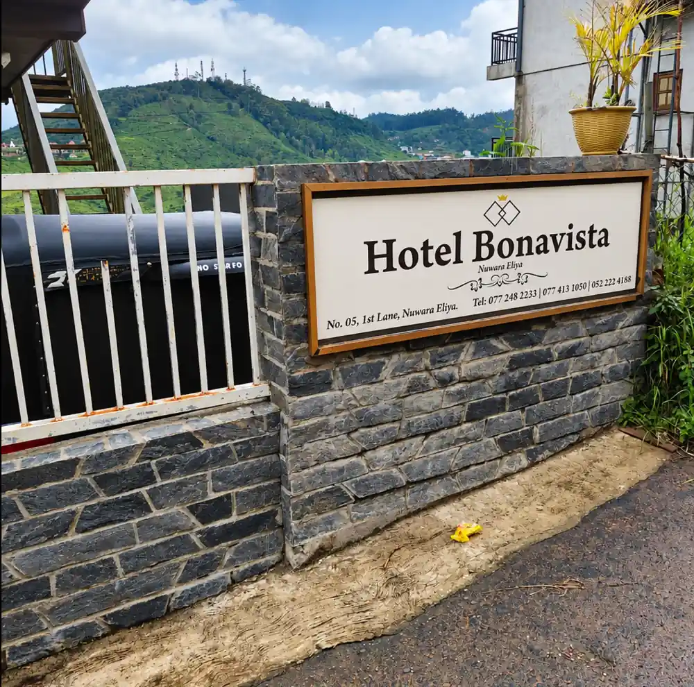 Entrance sign at Hotel Bonavista with the green Nuwara Eliya hills beyond
